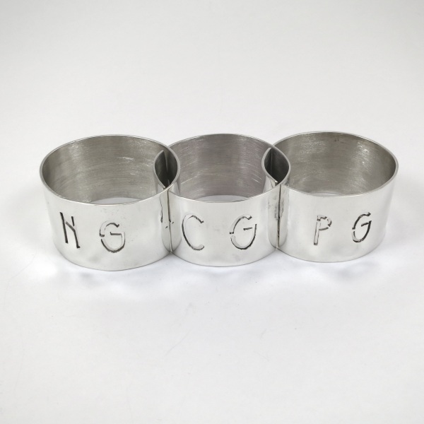 Linked set of three silver napkin rings